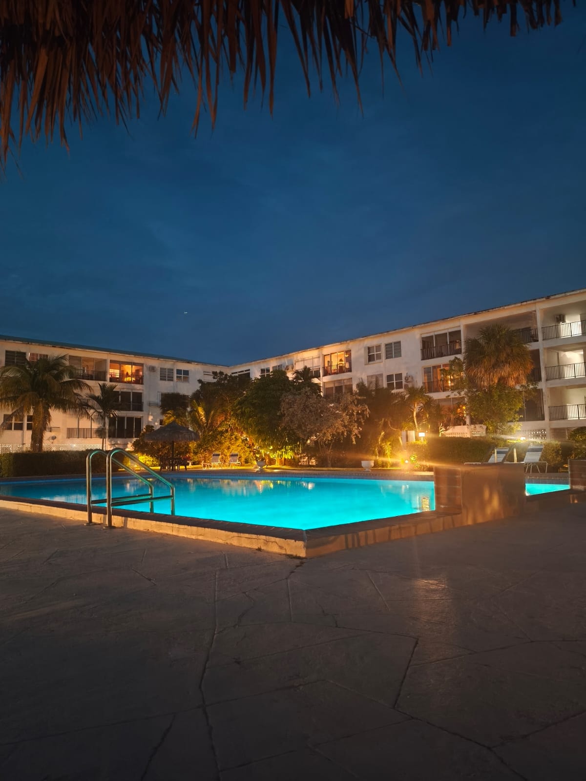 Jansel Court pool at night with illuminated buildings